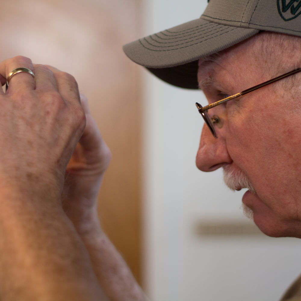Photo of an older man examining the back of his camera